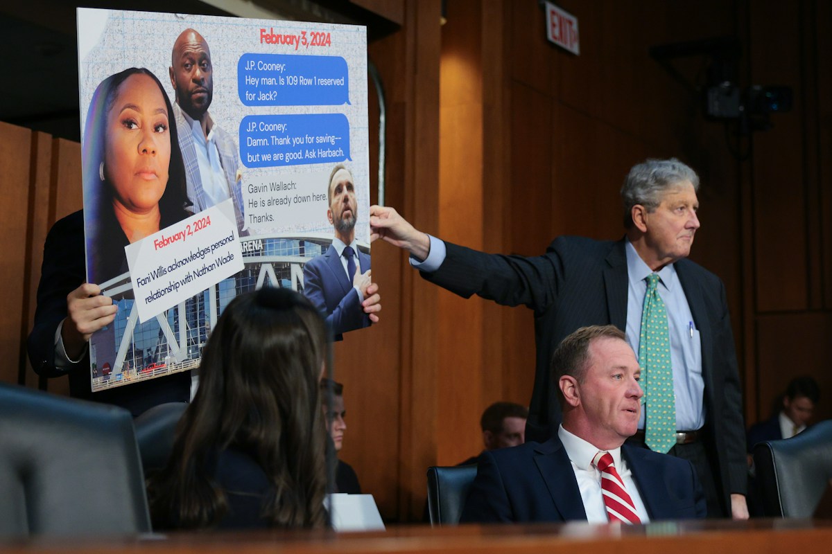 A text-message board held up behind Senator Schmitt at the hearing.